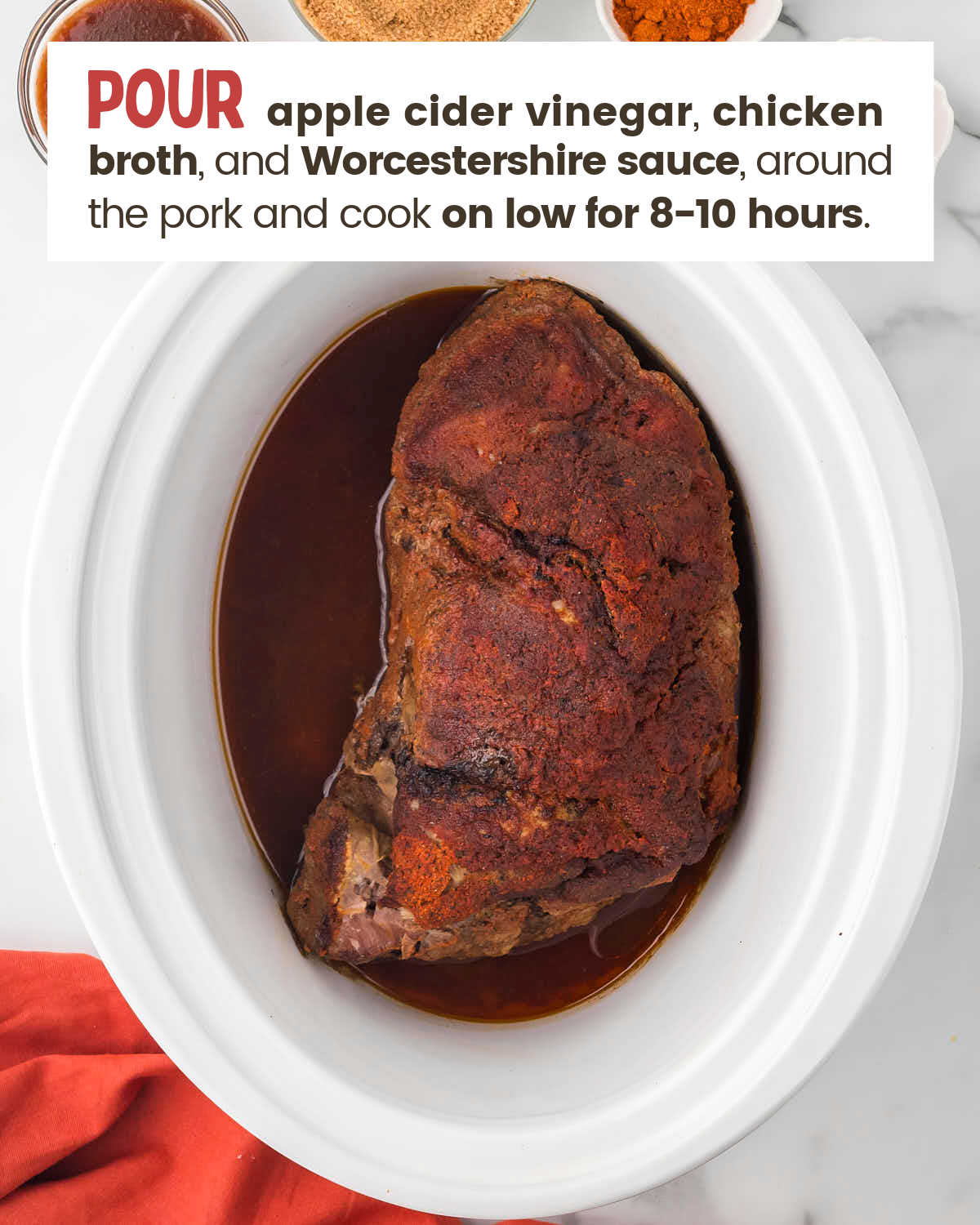 Pork shoulder in a slow cooker with cooking liquid.