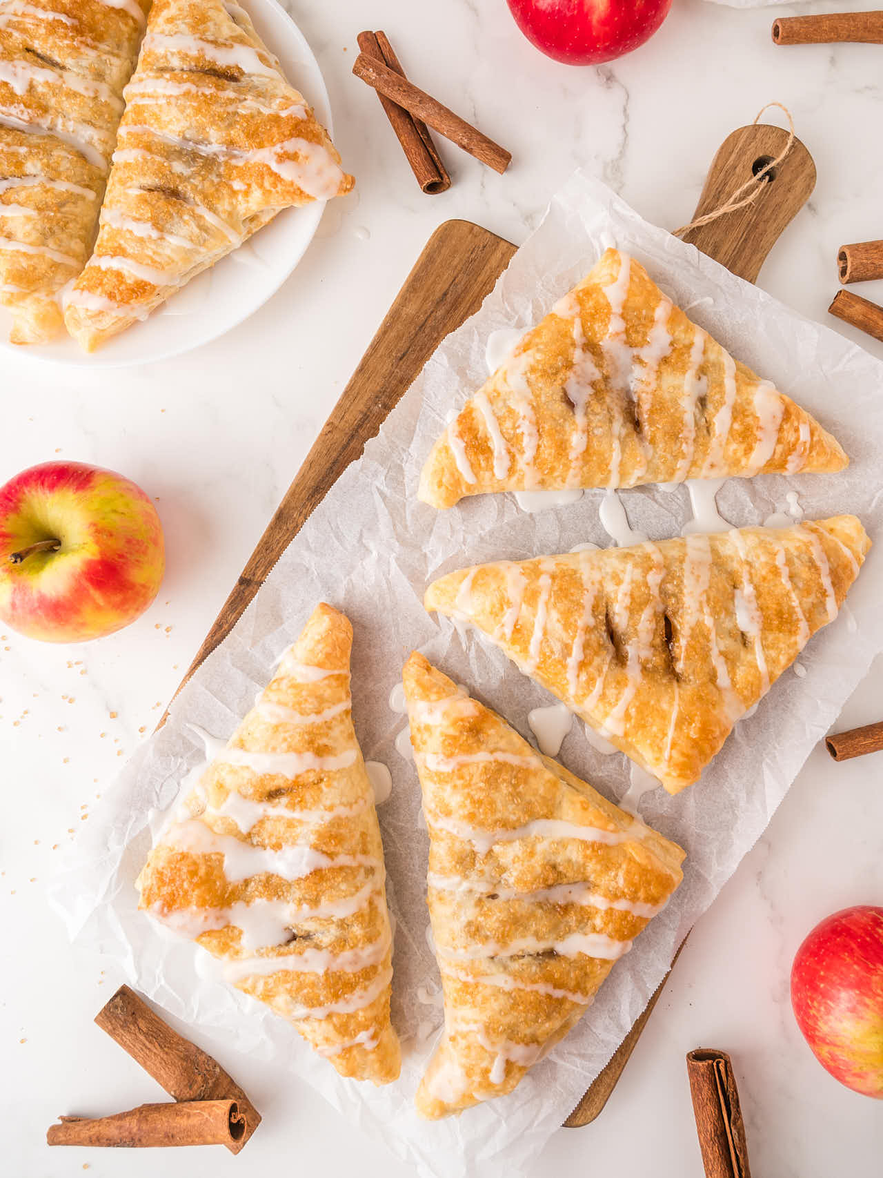 Topdown view of several Apple Turnovers  on a serving platter.