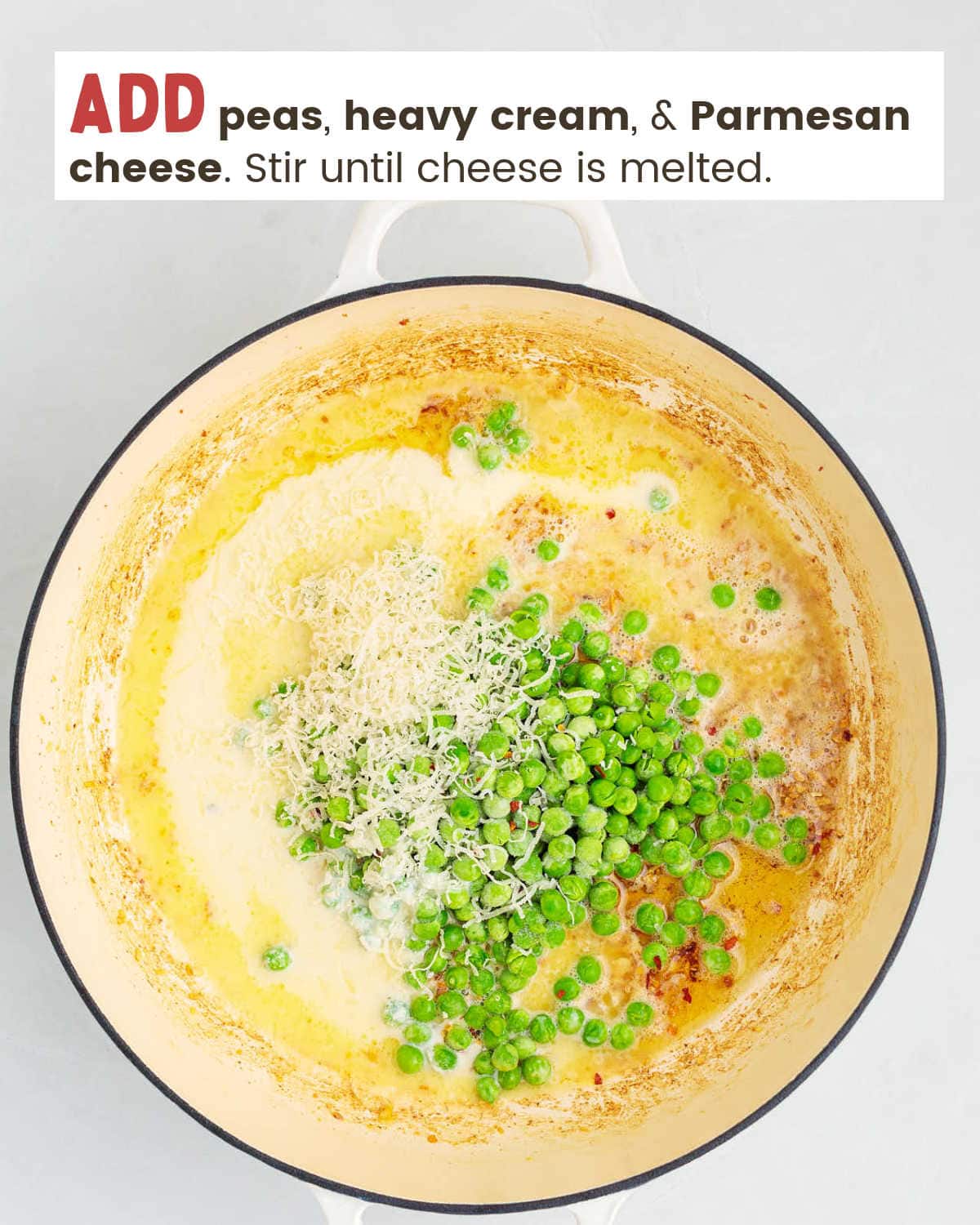 Frozen peas, heavy cream, and Parmesan cheese in a pan.