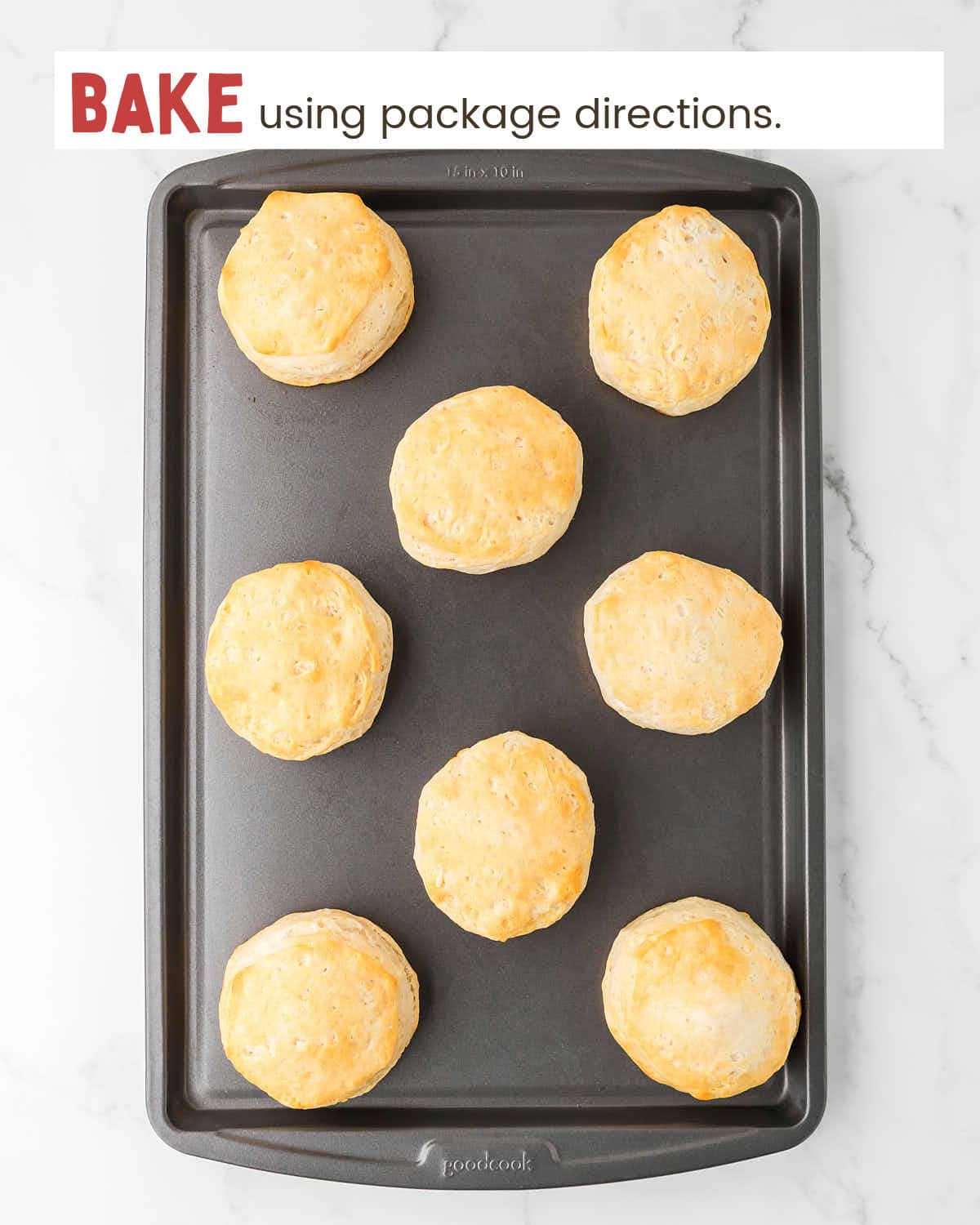 Baked canned biscuits on a baking sheet.