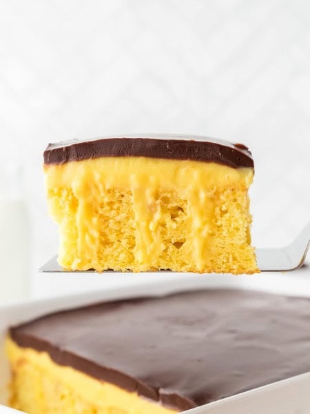 A slice of Boston Cream Cake recipe by Cheerful Cook.