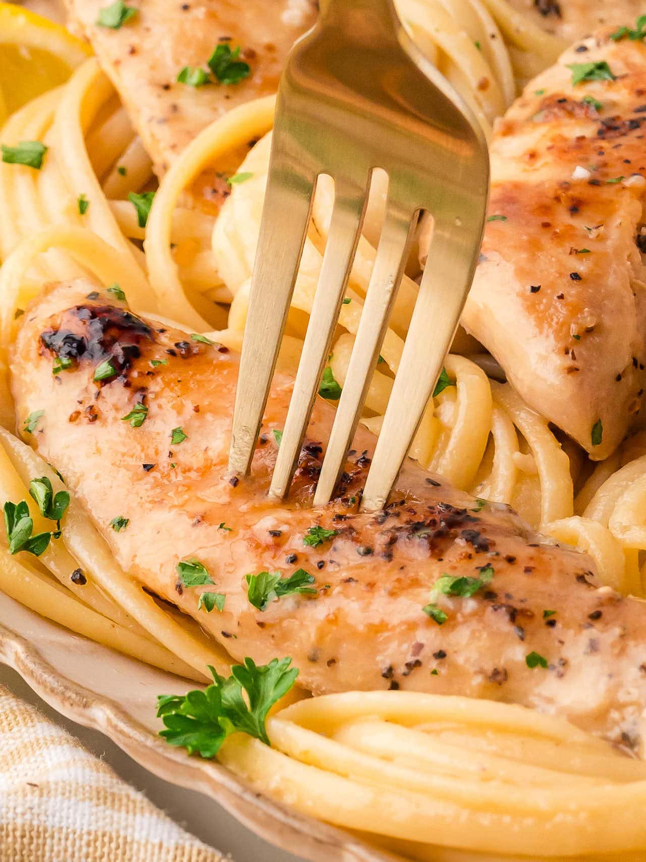 Pushing a fork into slice of chicken.