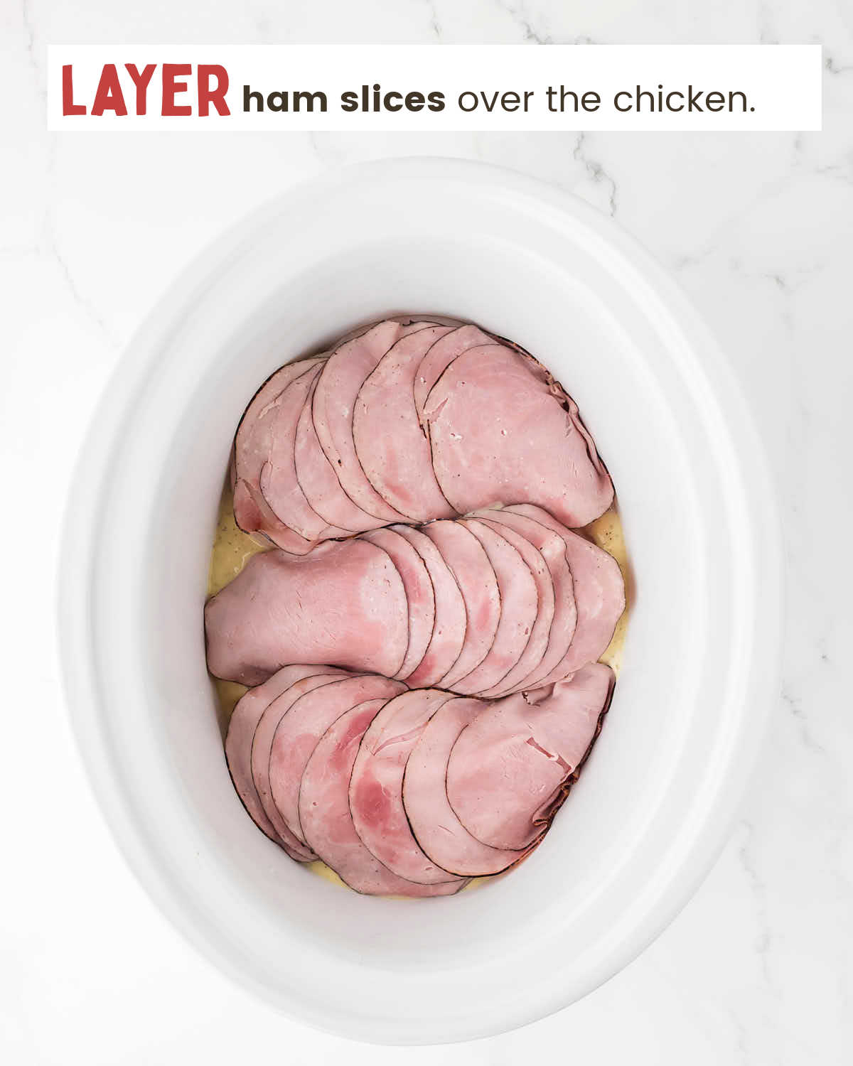 Deli ham slices over chicken breasts in a slow cooker.