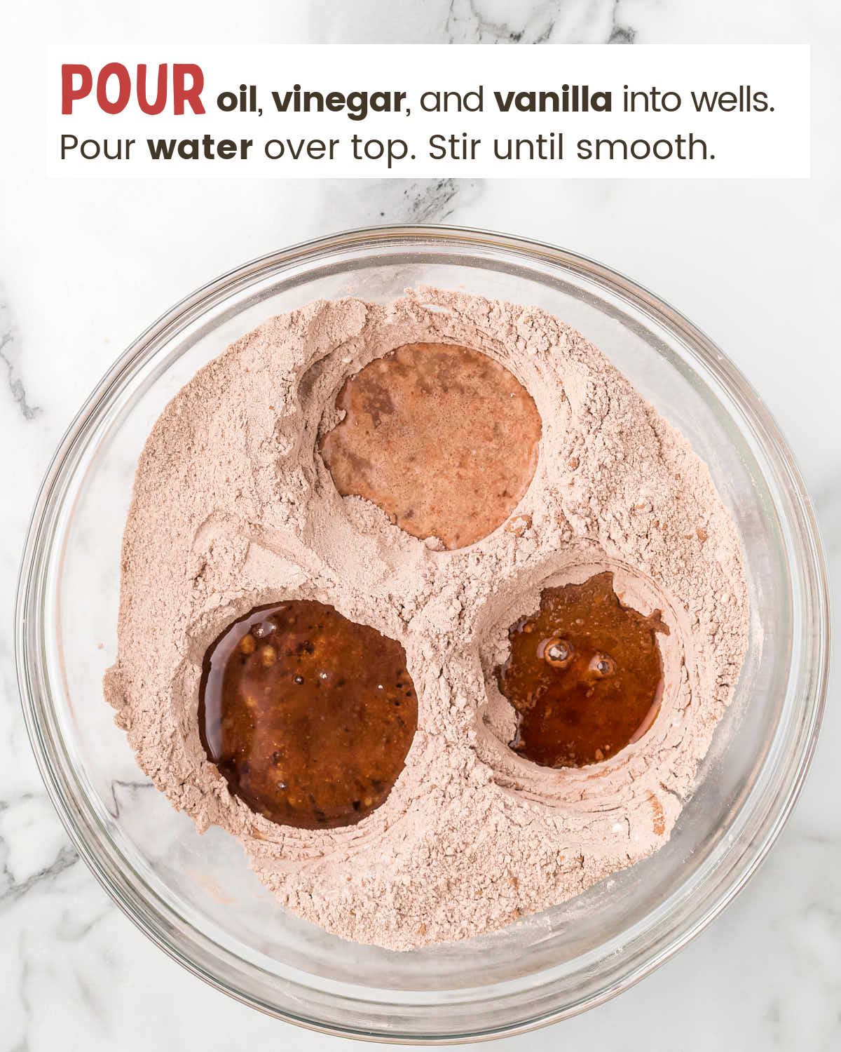 Cake dry ingredient mixture with 3 wells filled with wet ingredients.