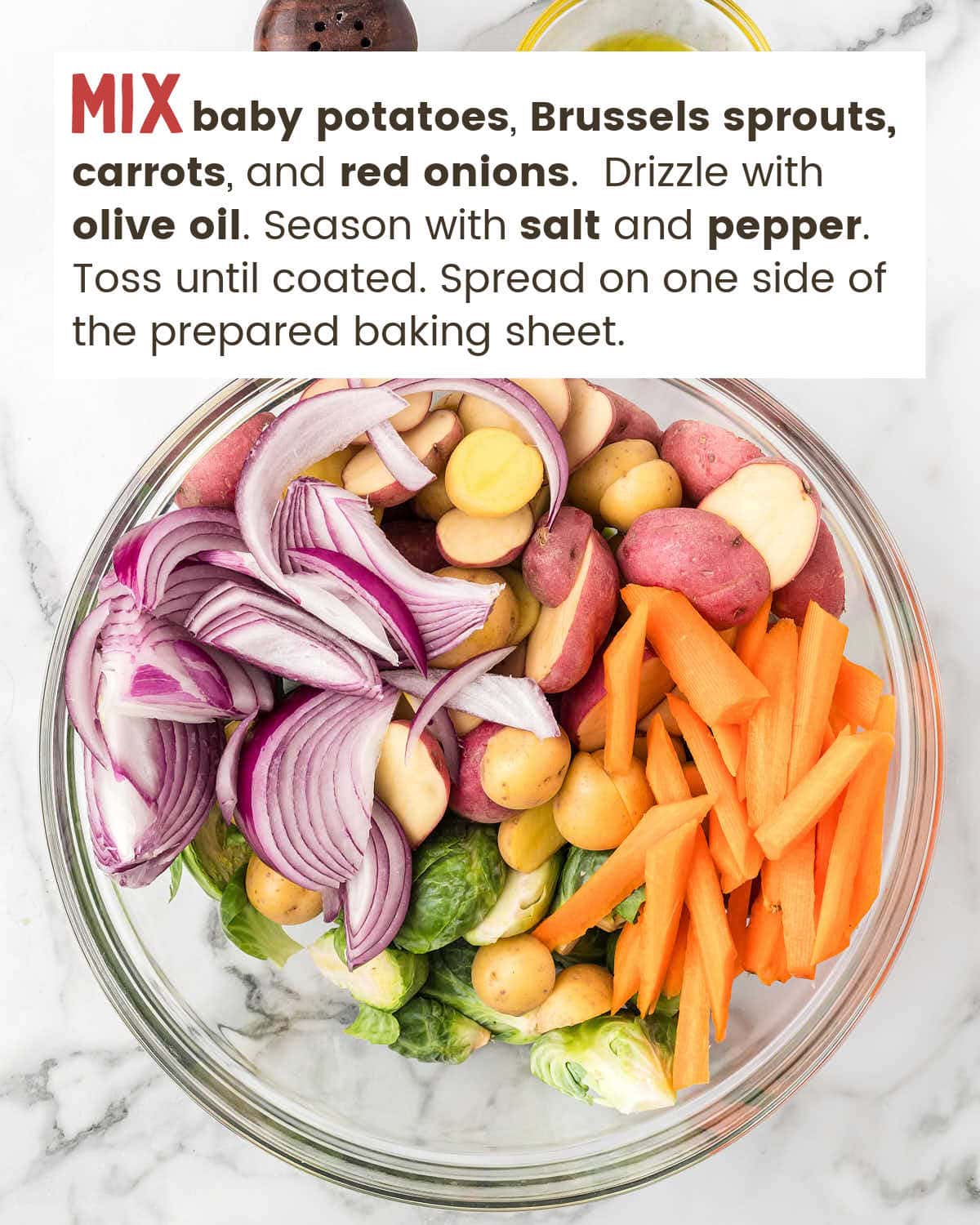 Red onions, baby potatoes, sliced carrots, and Brussels sprouts in a bowl.