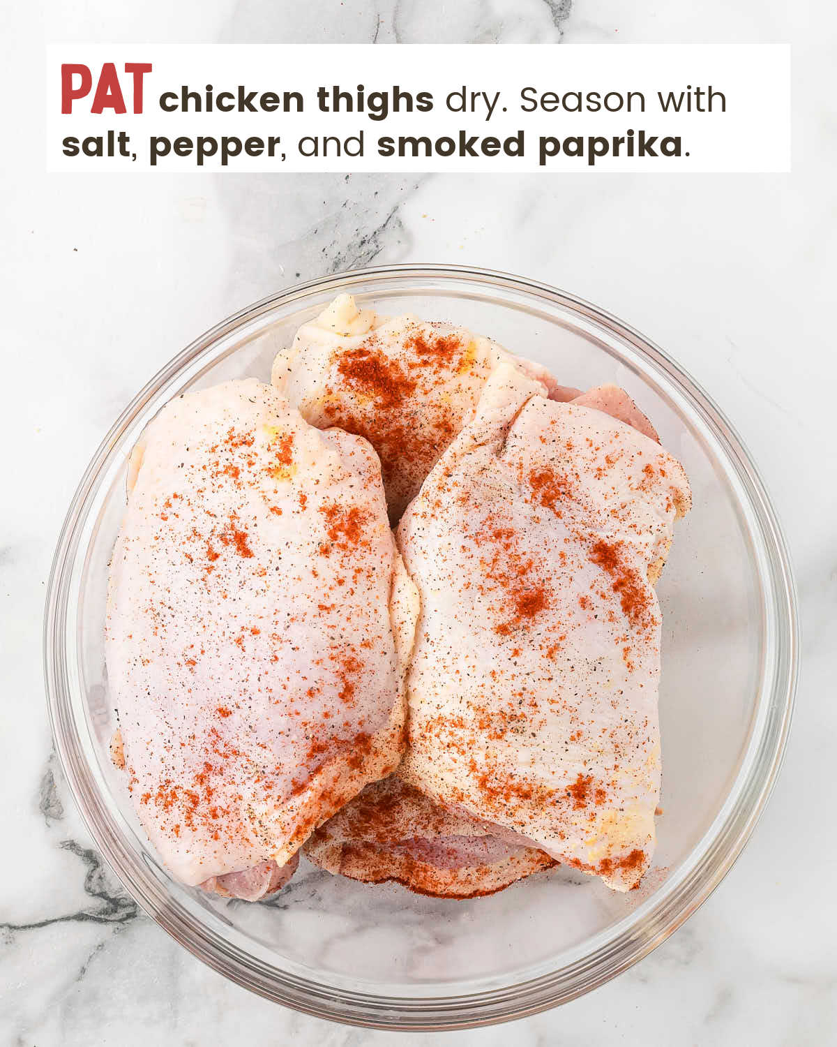 Skin-on chicken things coated with smoked paprika, salt, and pepper in a bowl.
