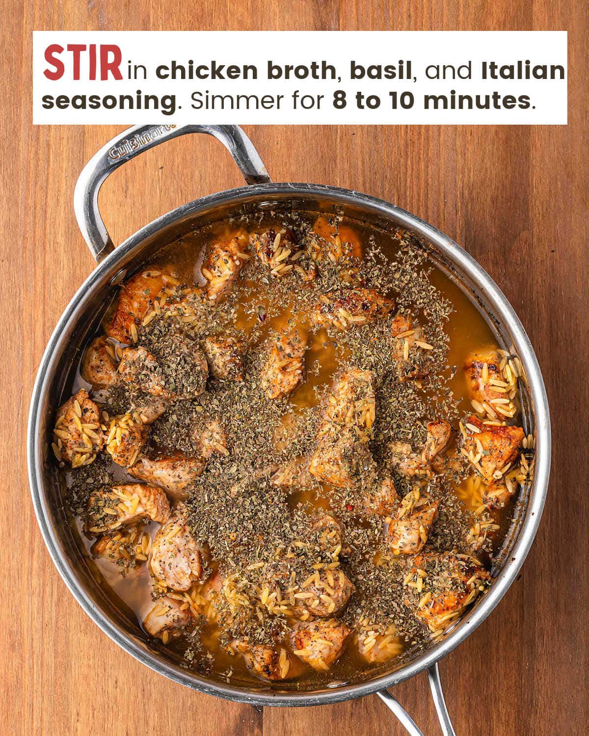 Chicken breast pieces with orzo and chicken broth in a skillet.