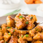 Closeup of a serving spoon of homemade Orange Chicken.