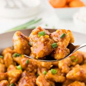 Closeup of a serving spoon of homemade Orange Chicken.