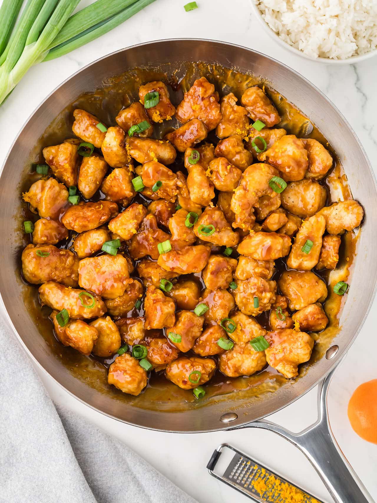 Topdown view of a skillet of homemade Orange Chicken.