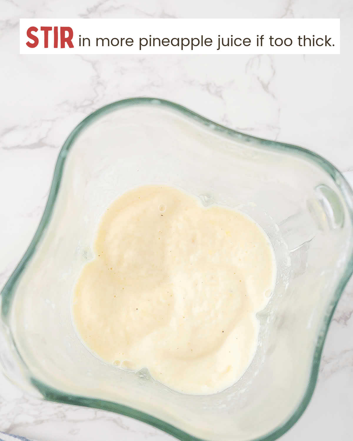 Top view of blended pineapple mixture in a blender.