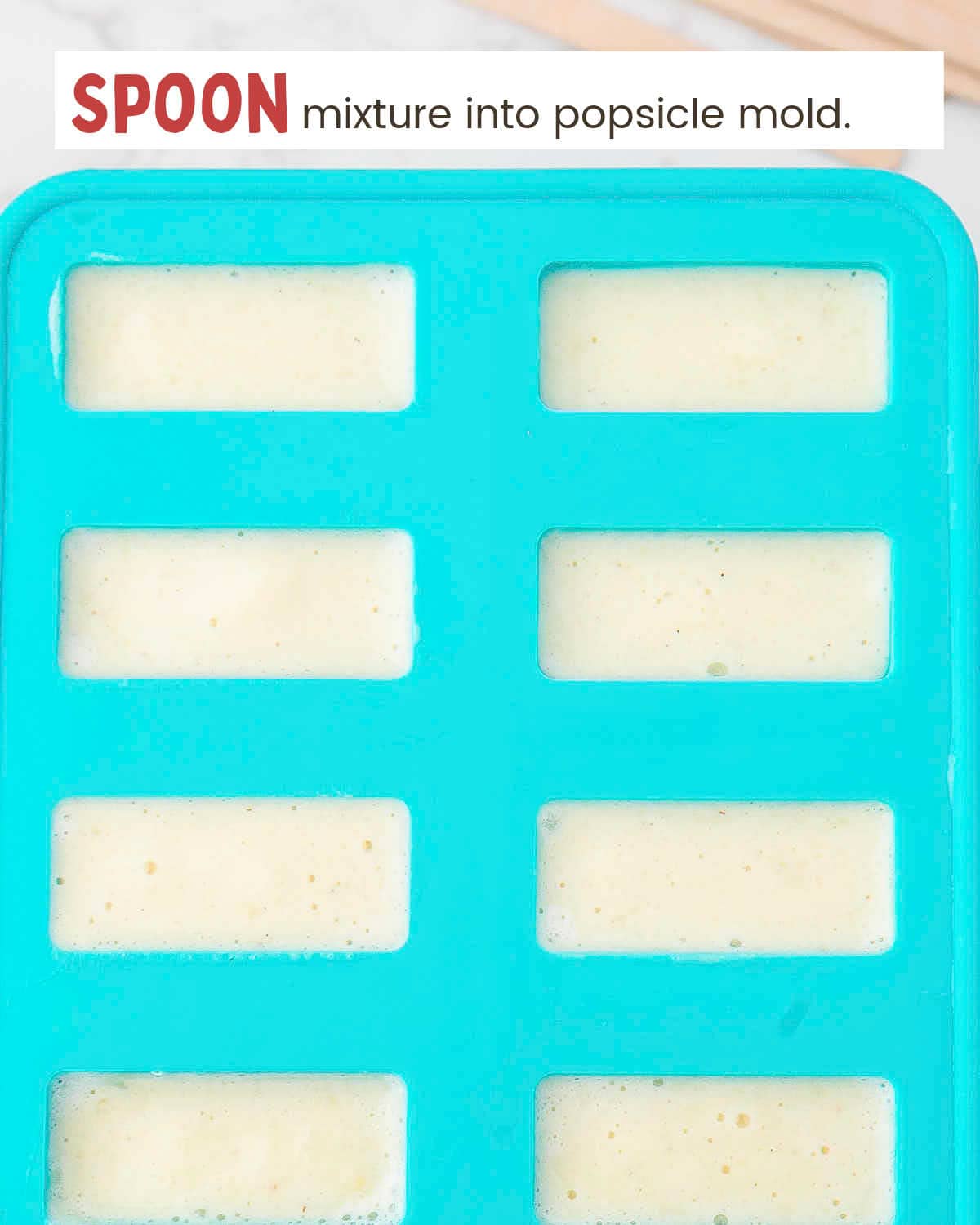 Pineapple mixture in a popsicle mold.