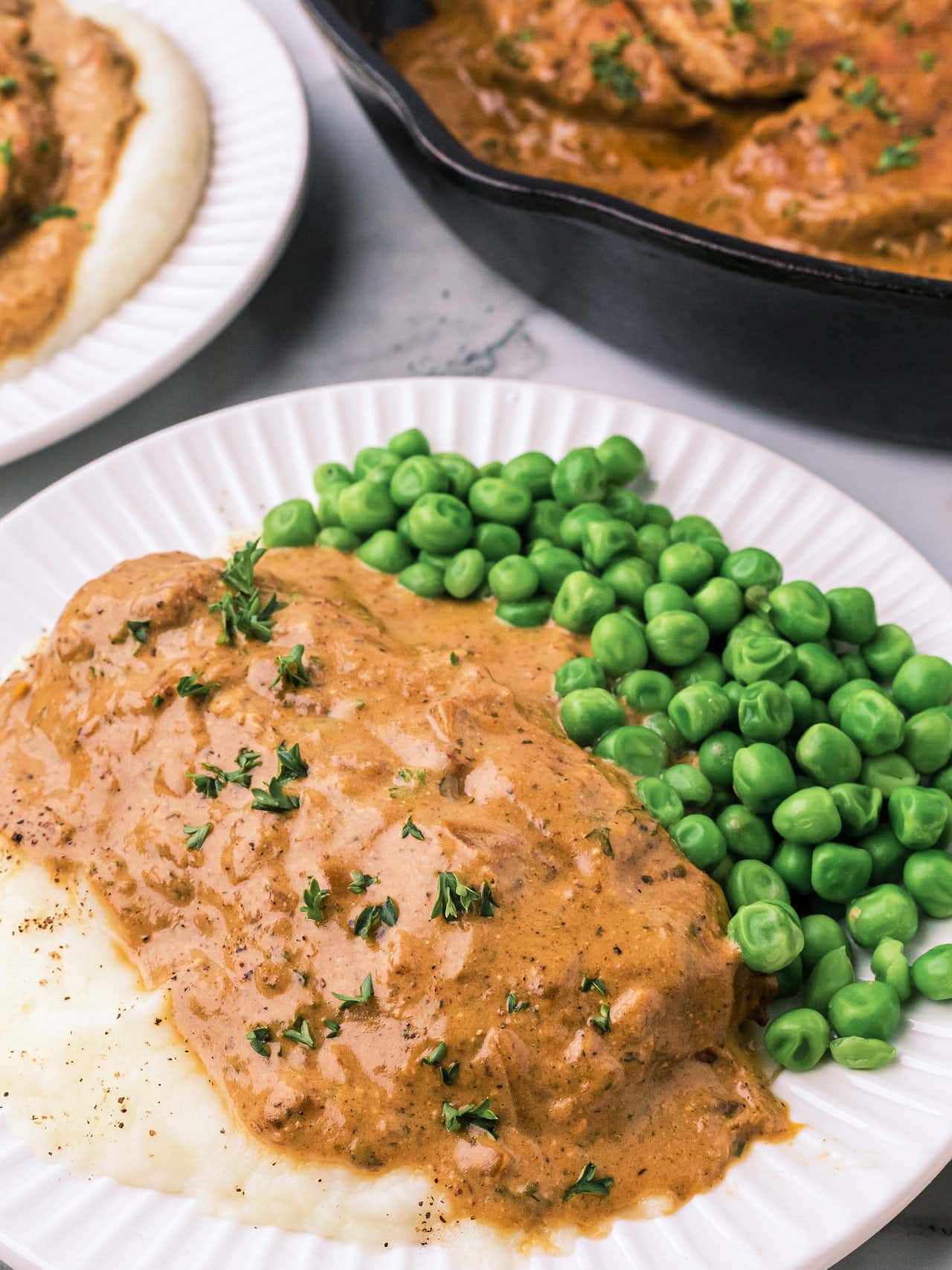 Ranch Chicken served over mashed potatoes and peas.