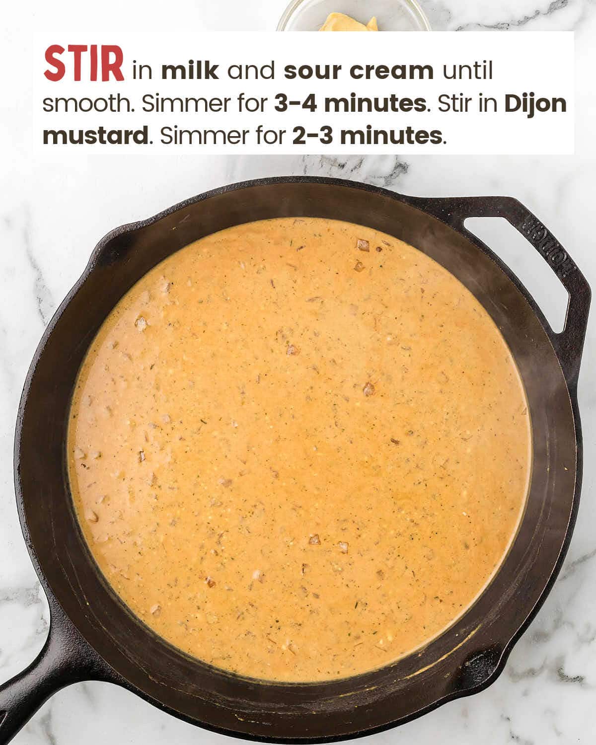 Dijon mustard ranch sauce in a cast iron skillet.