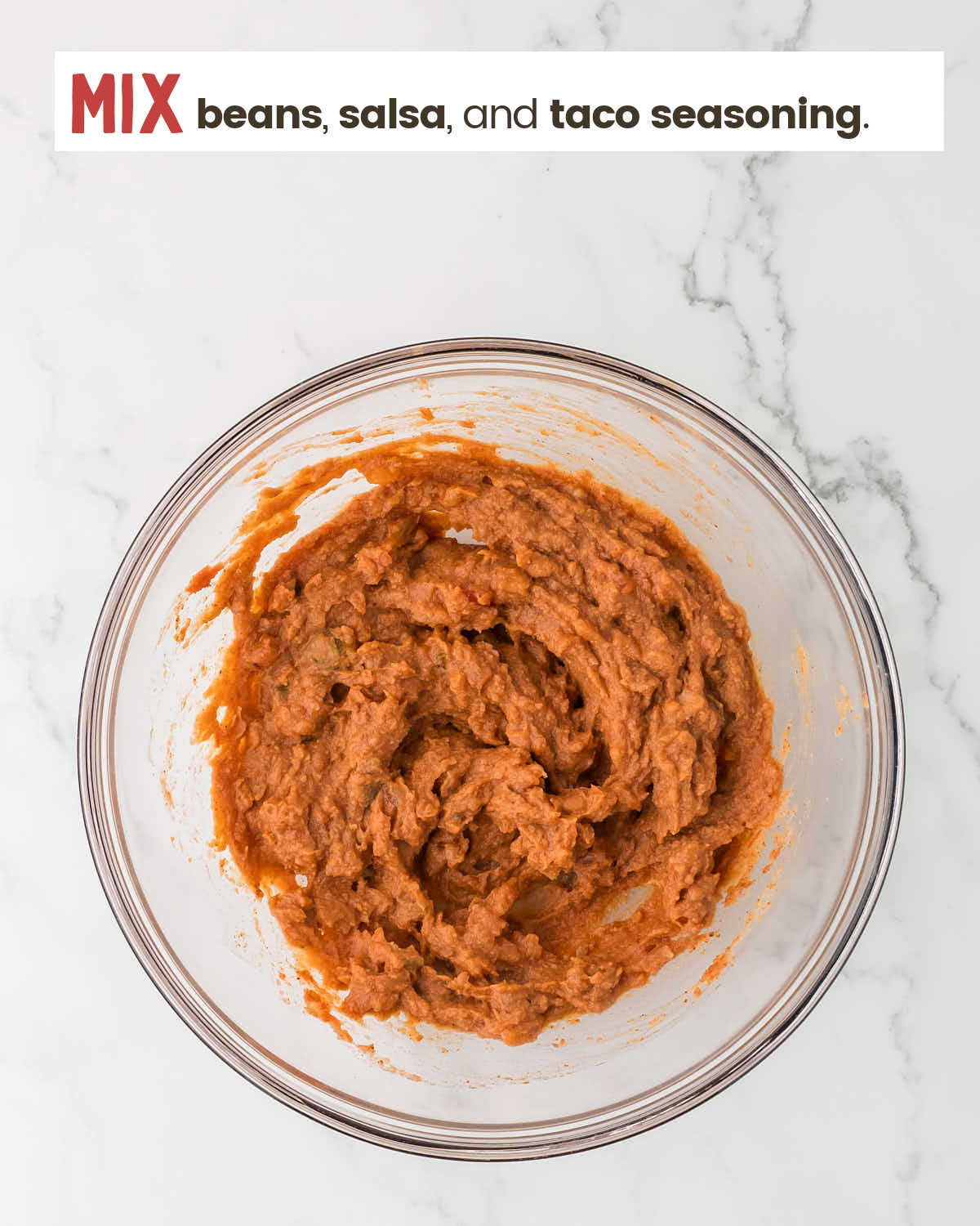 Refried bean mixture in a mixing bowl.