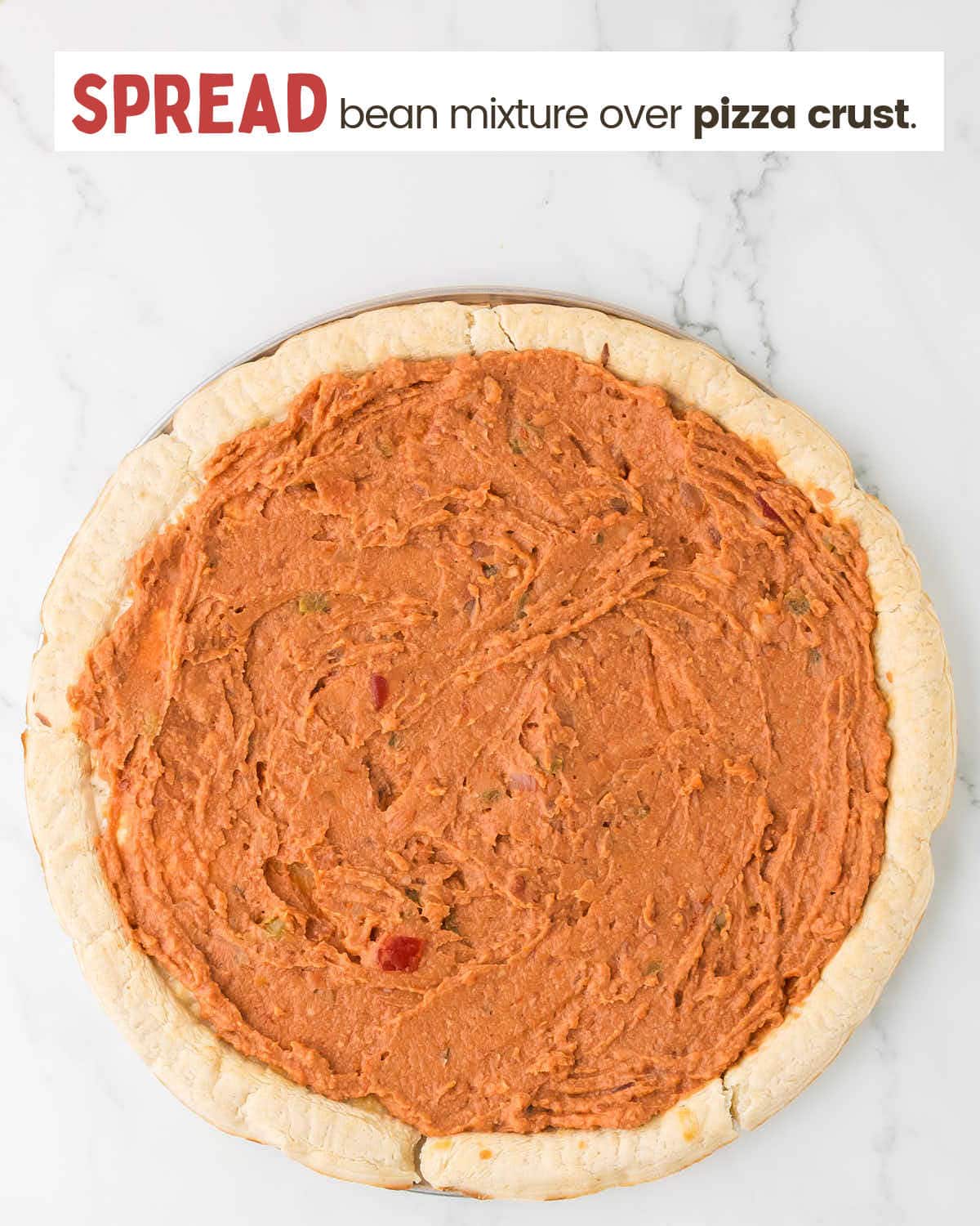 Refried bean mixture spread over pizza crust.