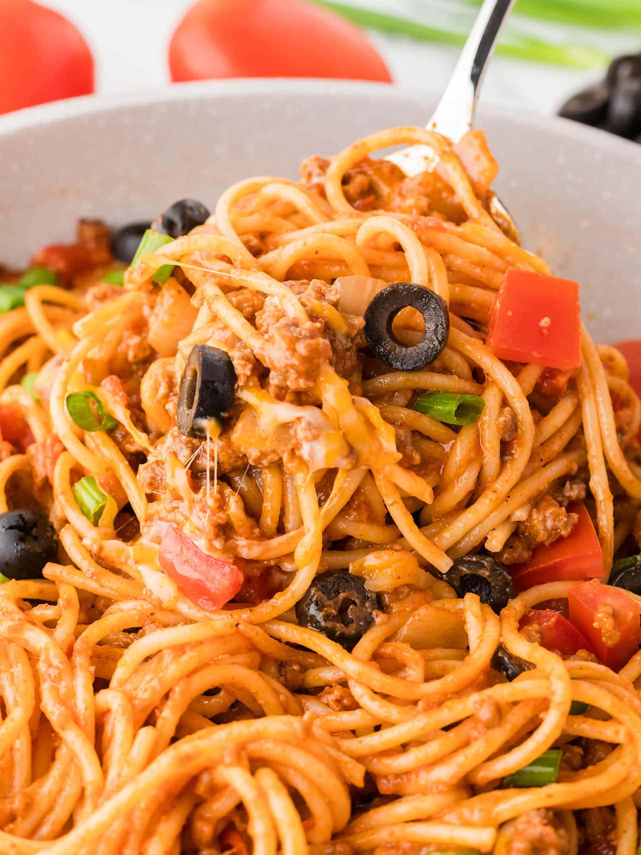 Removing Taco Spaghetti with a serving fork out of a skillet.