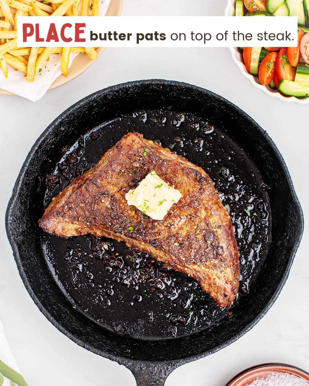 Tri-tip steak topped with a butter pat in a cast iron skillet.