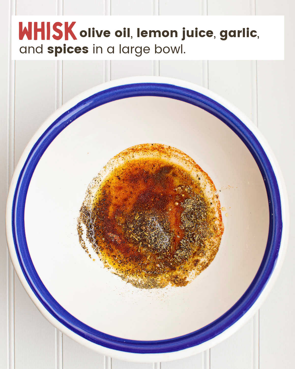 Olive oil, lemon juices, and spices in a bowl. 