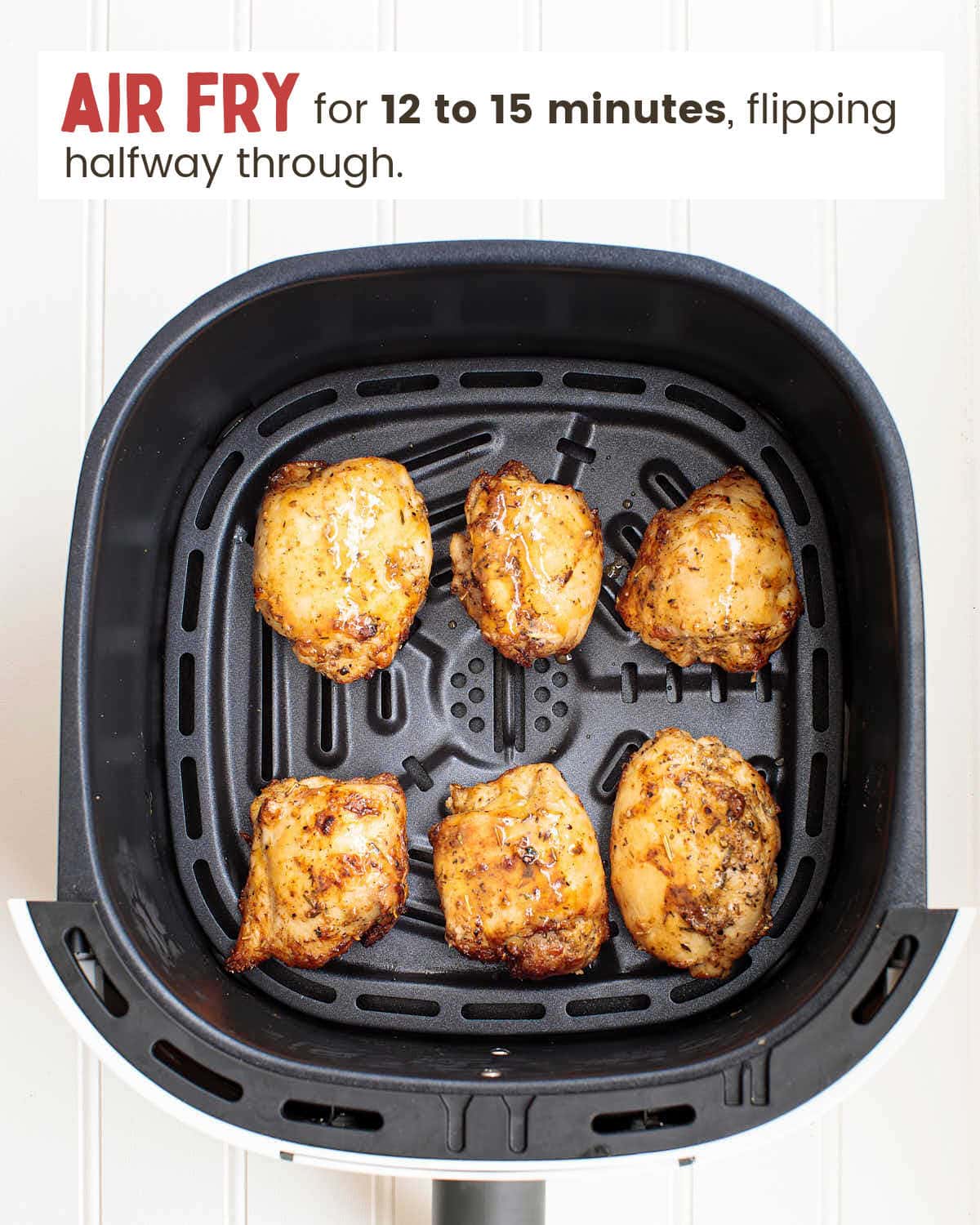 Air-fried chicken thighs in an air fryer.