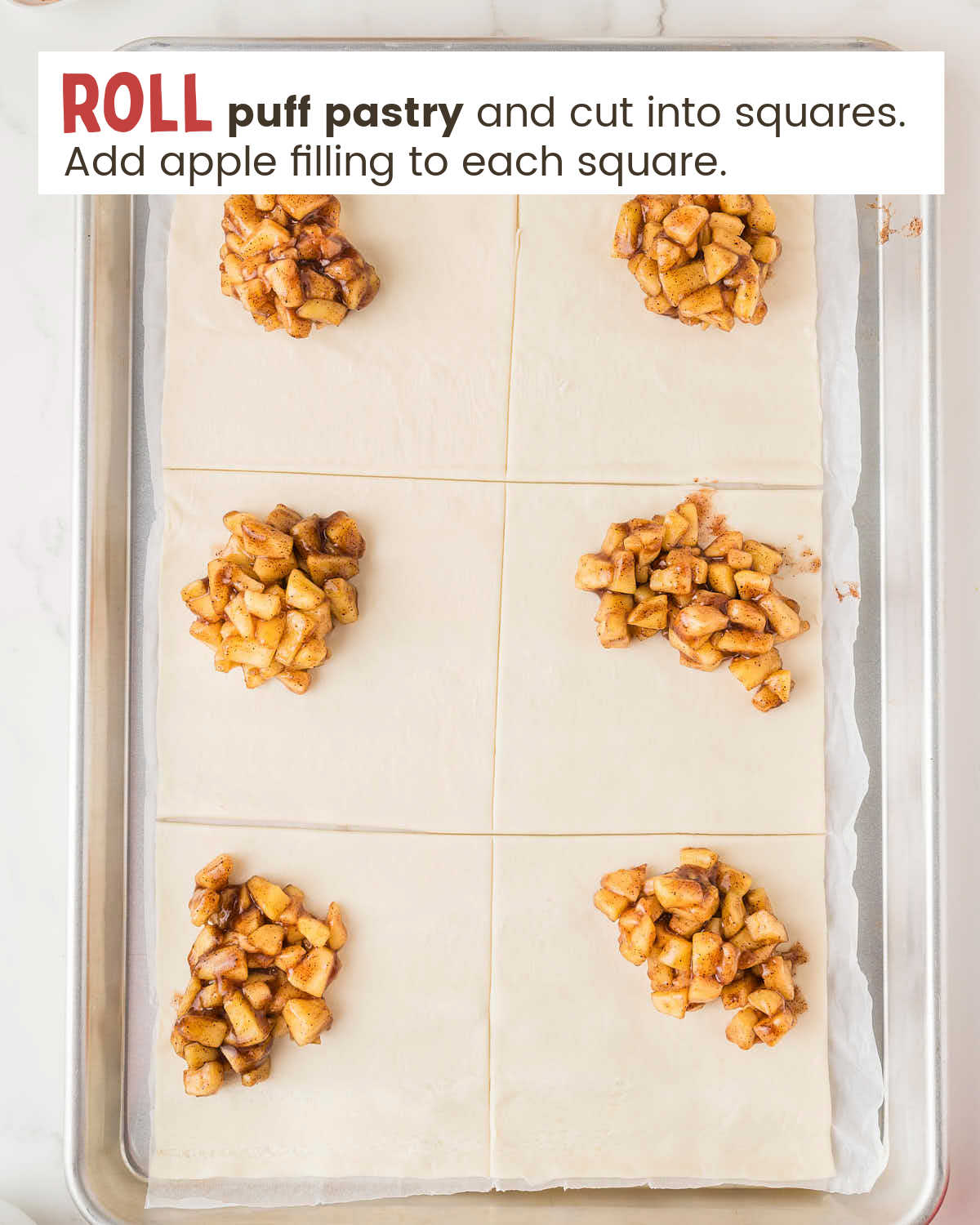 Flat puff pastry cut into six squares topped with a dollop of apple filling.