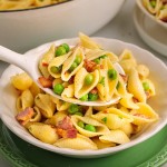 A serving spoonful of creamy Bacon Pasta with Peas.