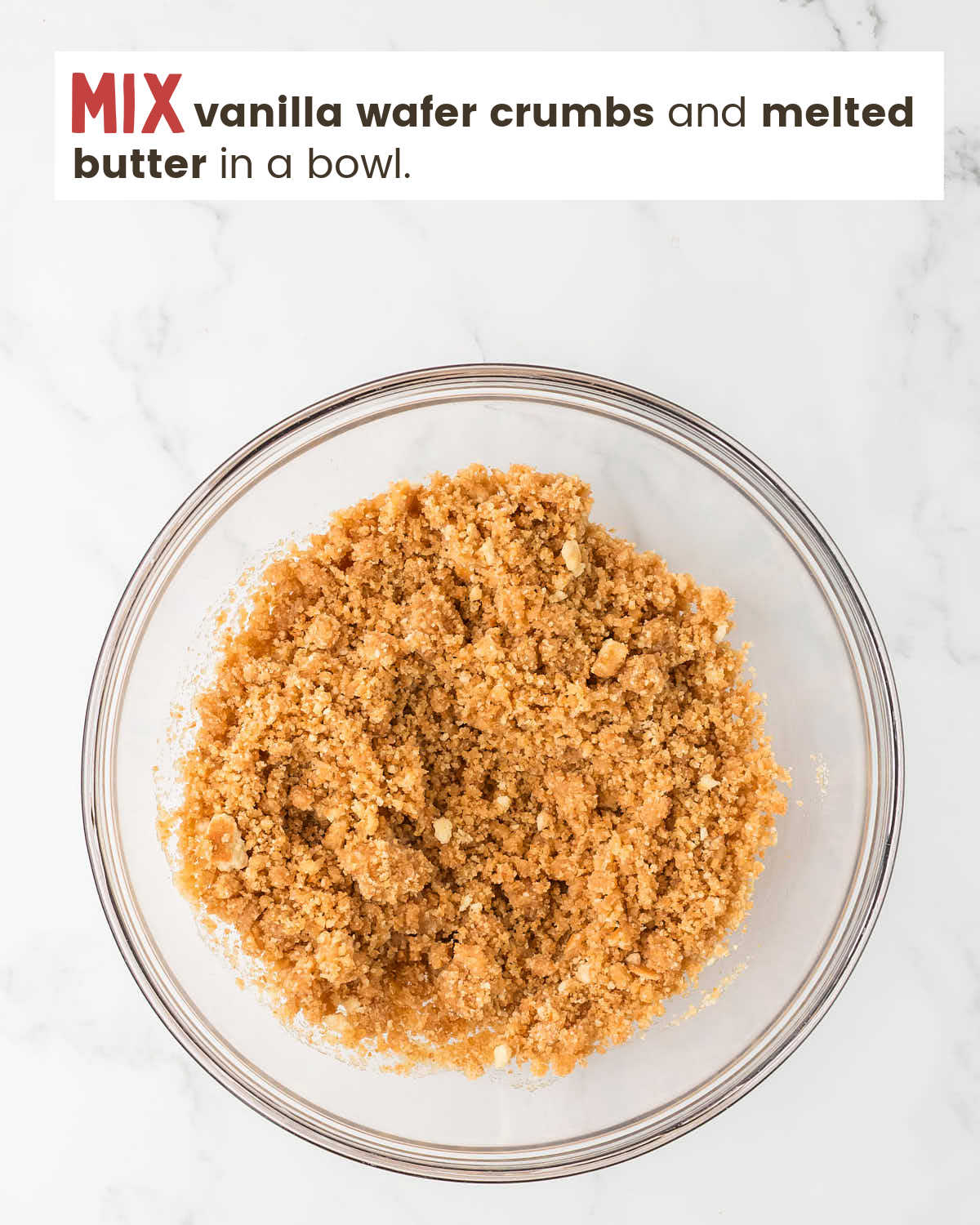 Melted butter mixed with vanilla wafer crumbs in a bowl. 