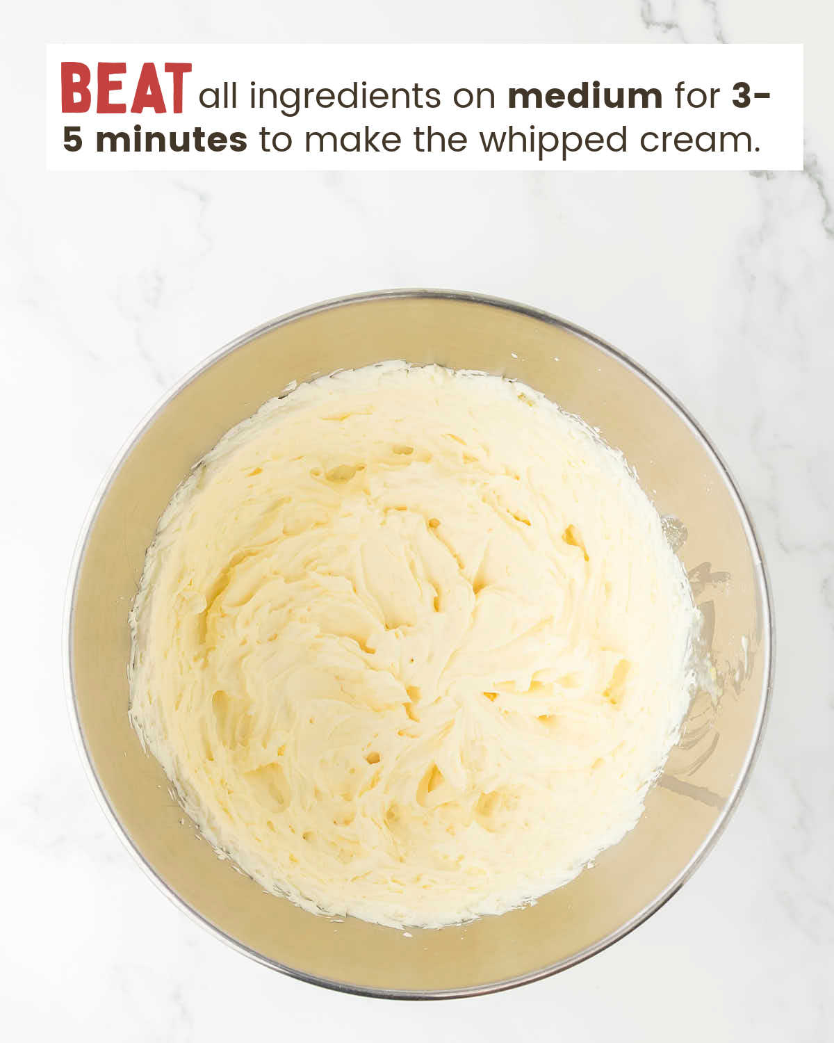 Whipped cream in a mixing bowl.