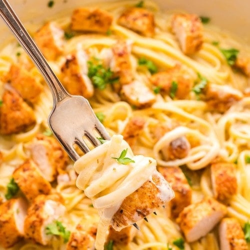 Blackened Chicken Alfredo with parsley and cheese.