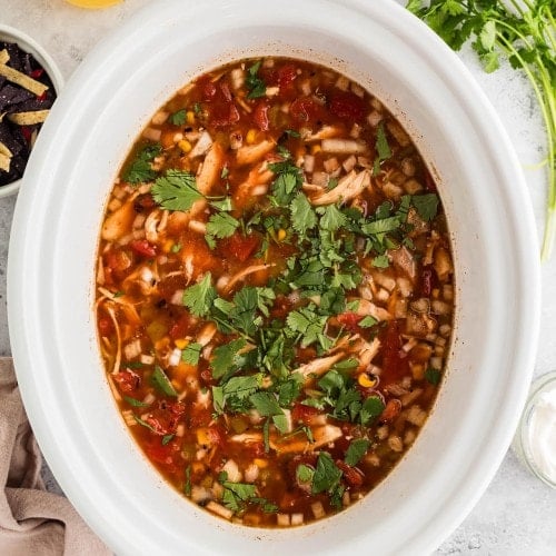 Chicken Tortilla Soup in a white Crockpot.
