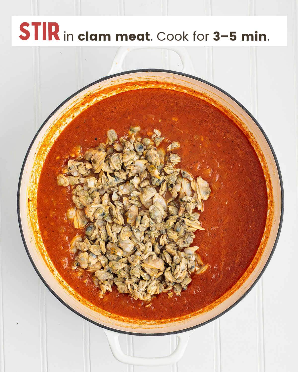Red sauce topped with calm meat in a skillet.