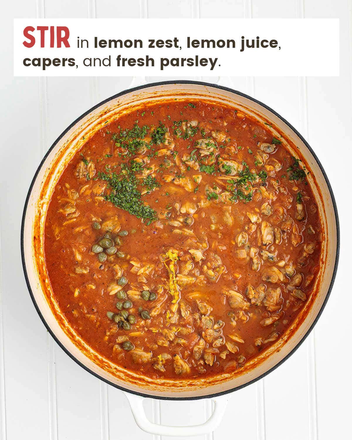 Red sauce, clam meat, and seasonings in a skillet.