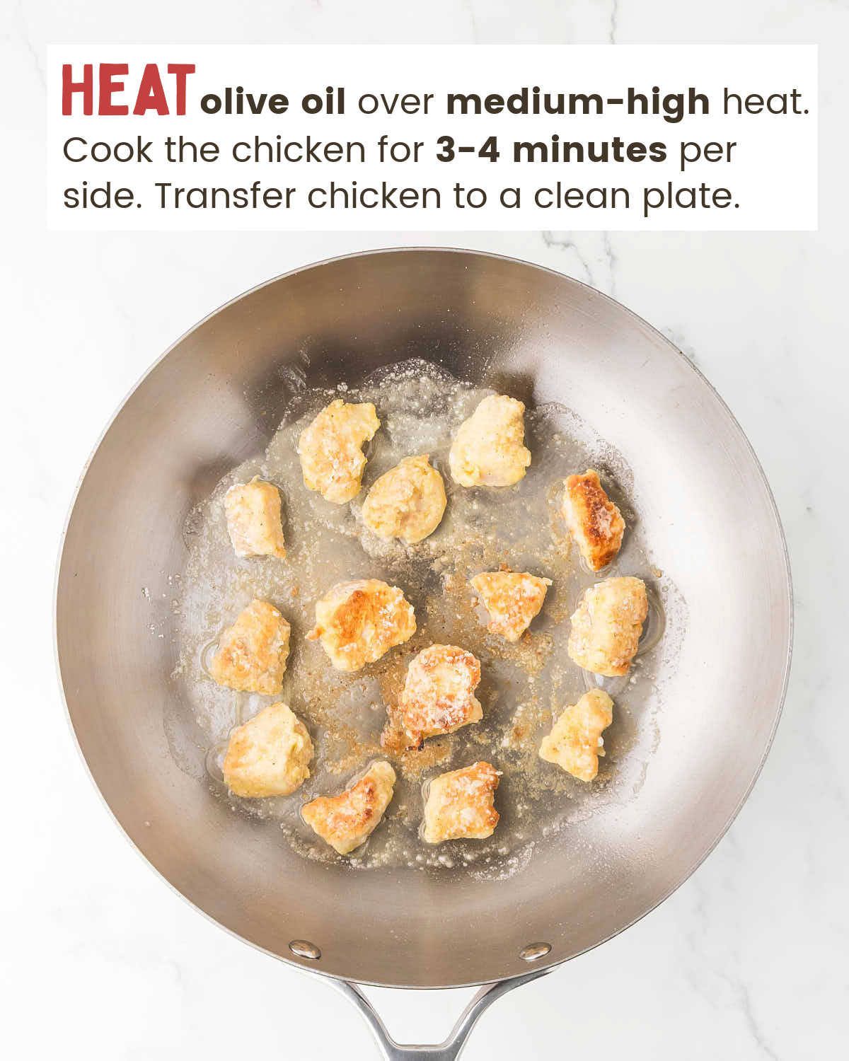 Chicken pieces in frying in olive oil in a skillet.