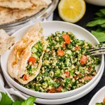 A bowl of Tabouli (Tabbouleh salad) and pita.