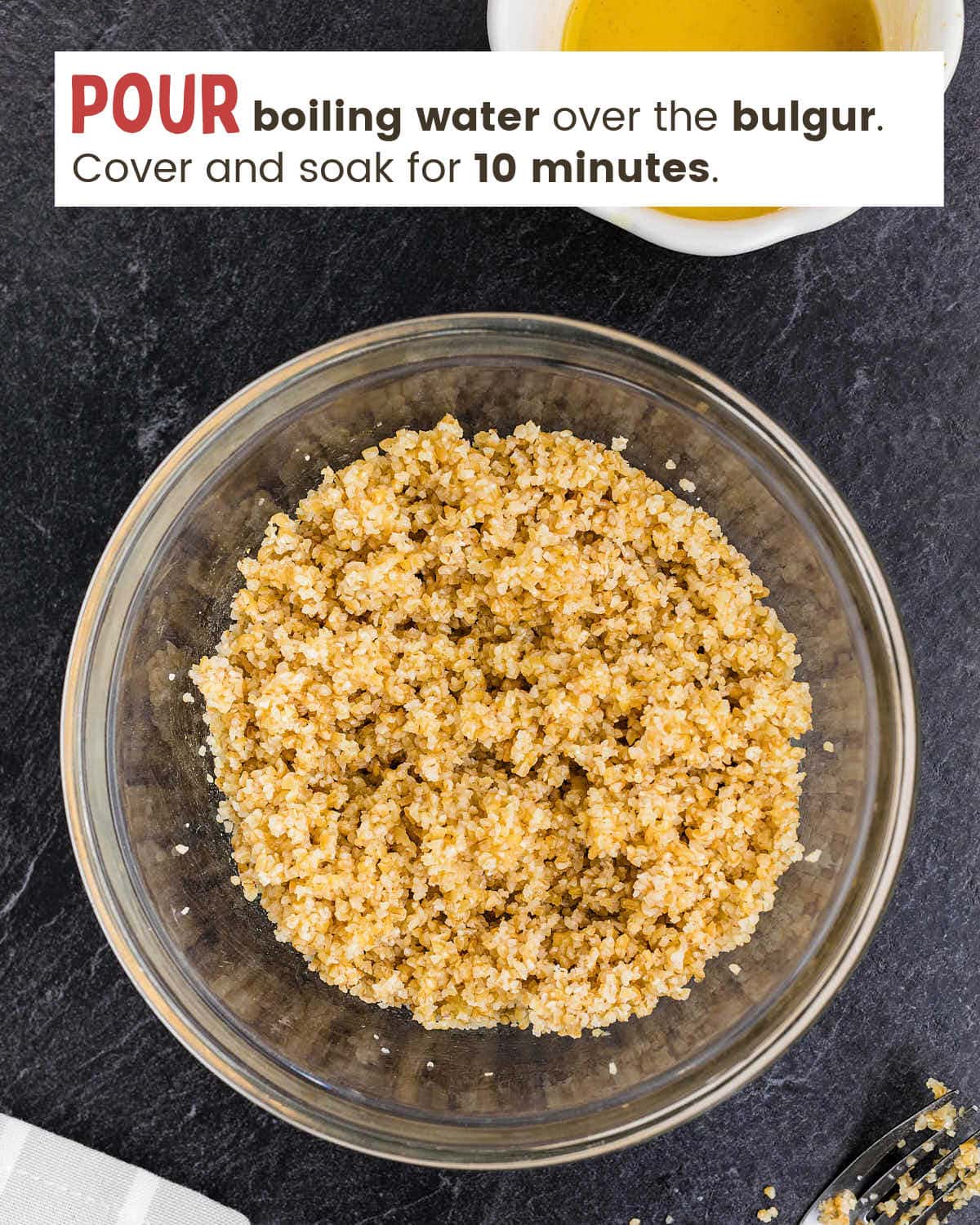 Wheat bulgar soaking in water in a bowl. 