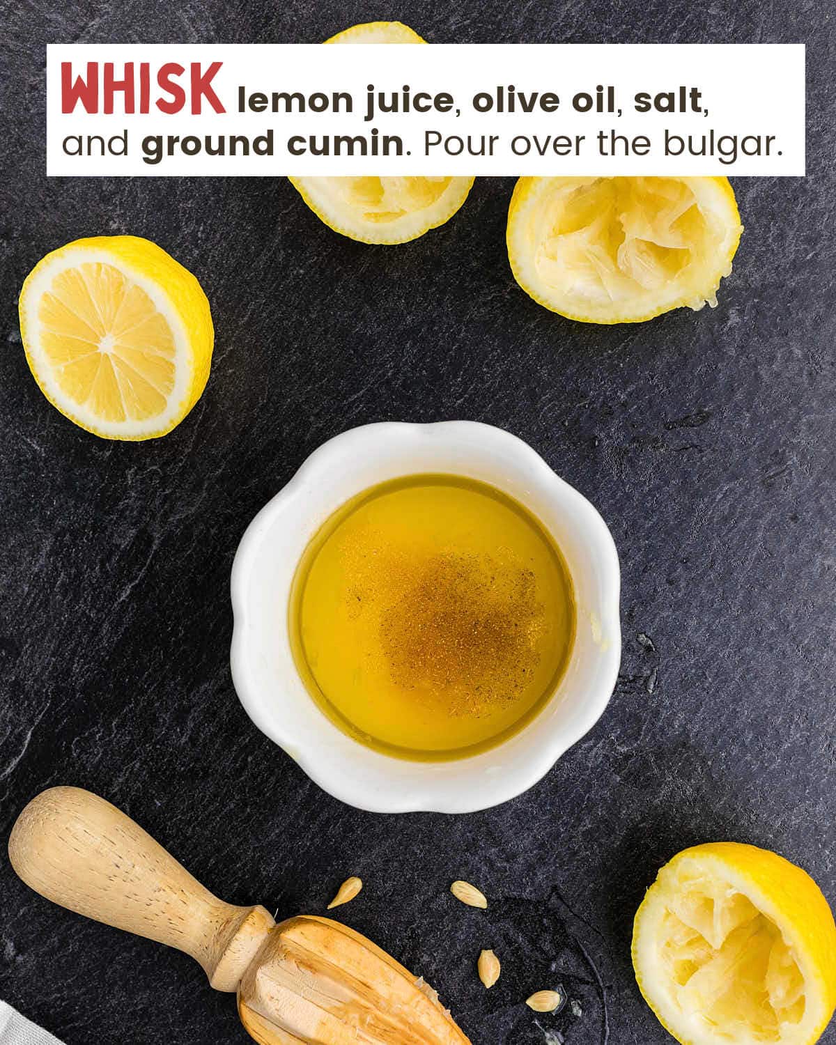 Halved lemons, a juicer, and a dish with ingredients for lemon dressing.