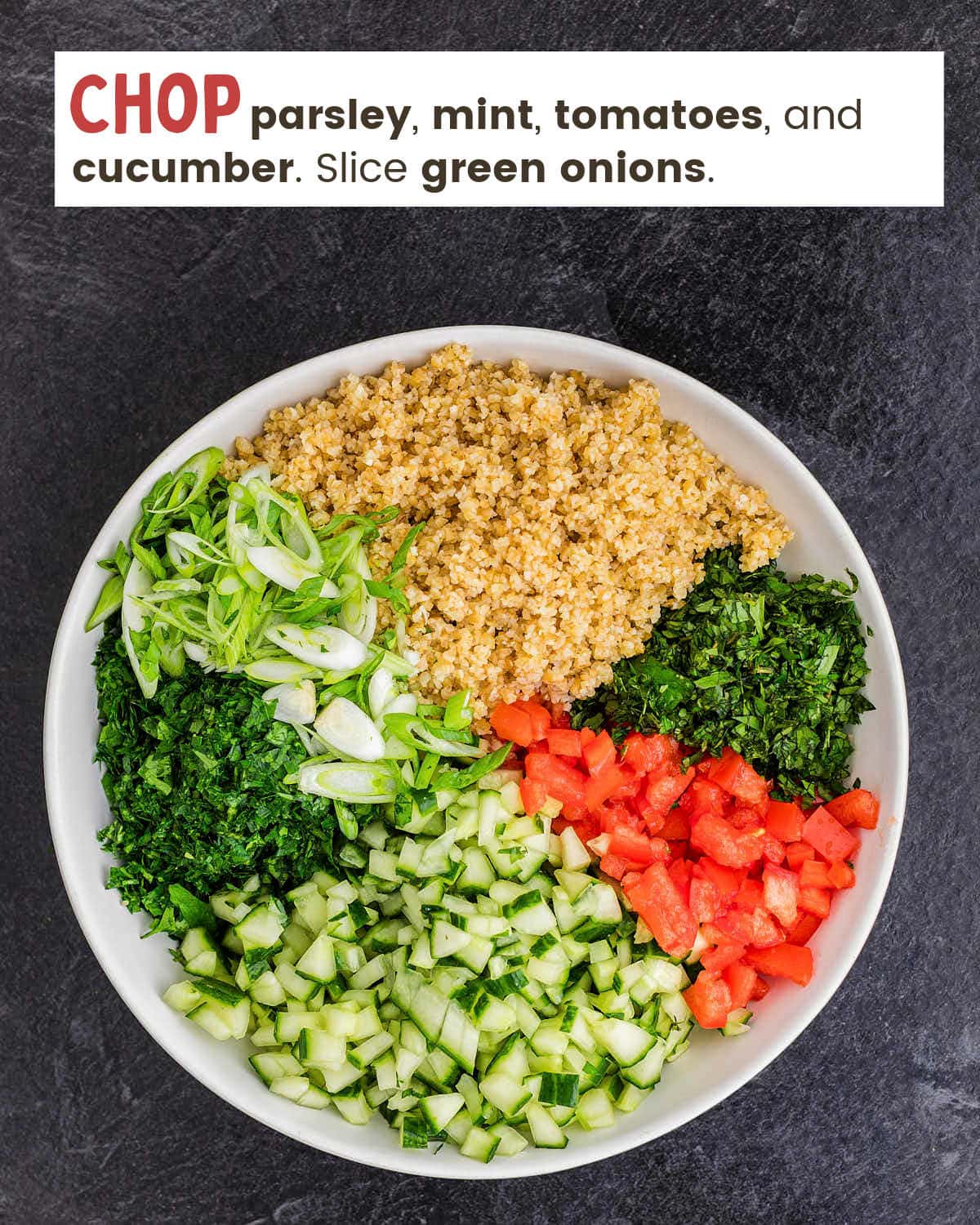 Wheat bulgur, chopped parsley, chopped tomatoes, chopped cucumbers, chopped parsley, and sliced green onions in a white bowl.