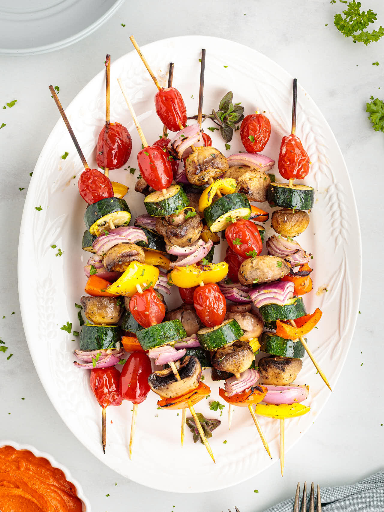 Grilled Veggie Kabobs on a white plate.