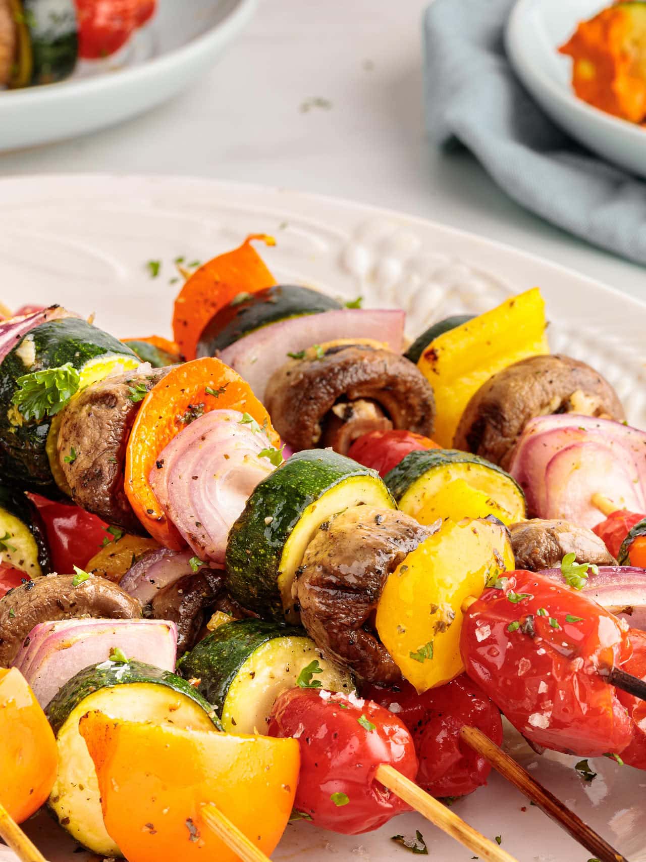 Closeup of a Veggie Kabobs on a white plate.