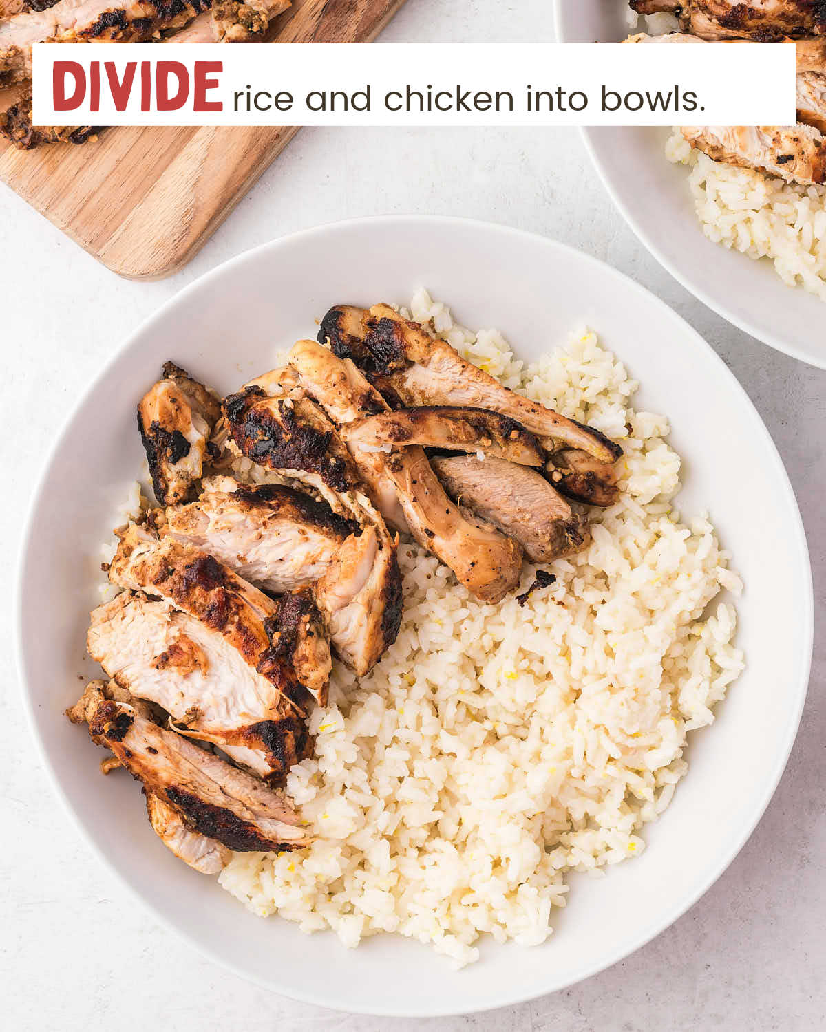 Sliced chicken on top of rice in a bowl.