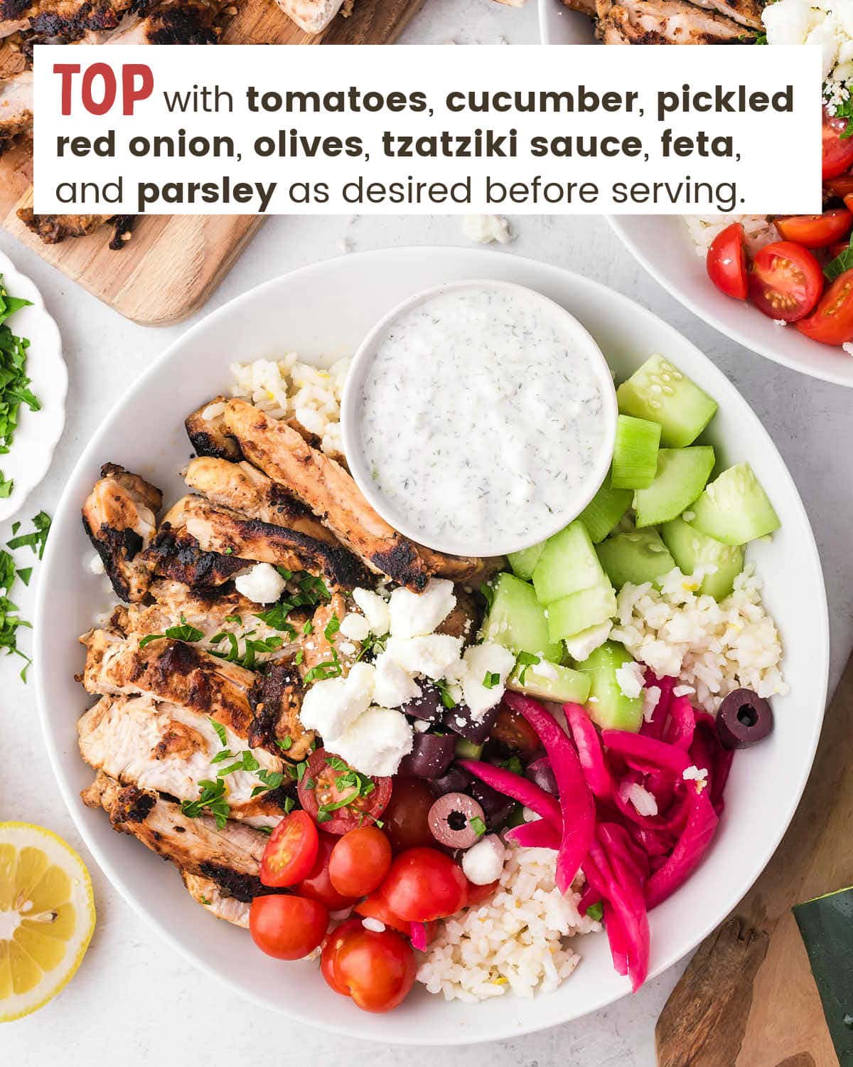 Greek chicken bowl. A bowl with chicken, tomatoes, cucumber, pickled red onion, olives, tzatziki sauce, feta, and parsley.