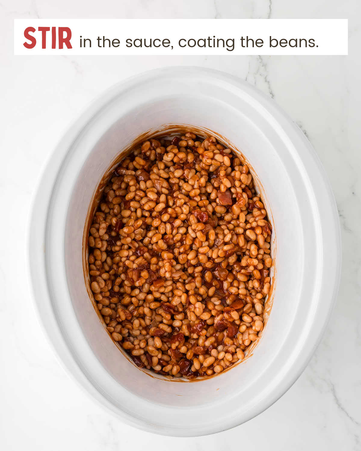 Beans coated with BBQ sauce in a slow cooker.