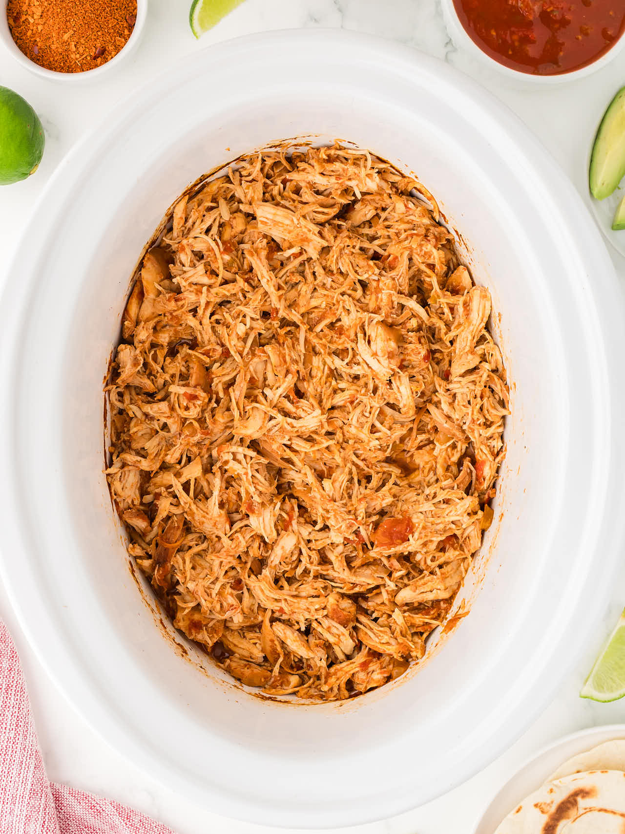 Top down view of Crockpot Chicken Salsa with sides. 