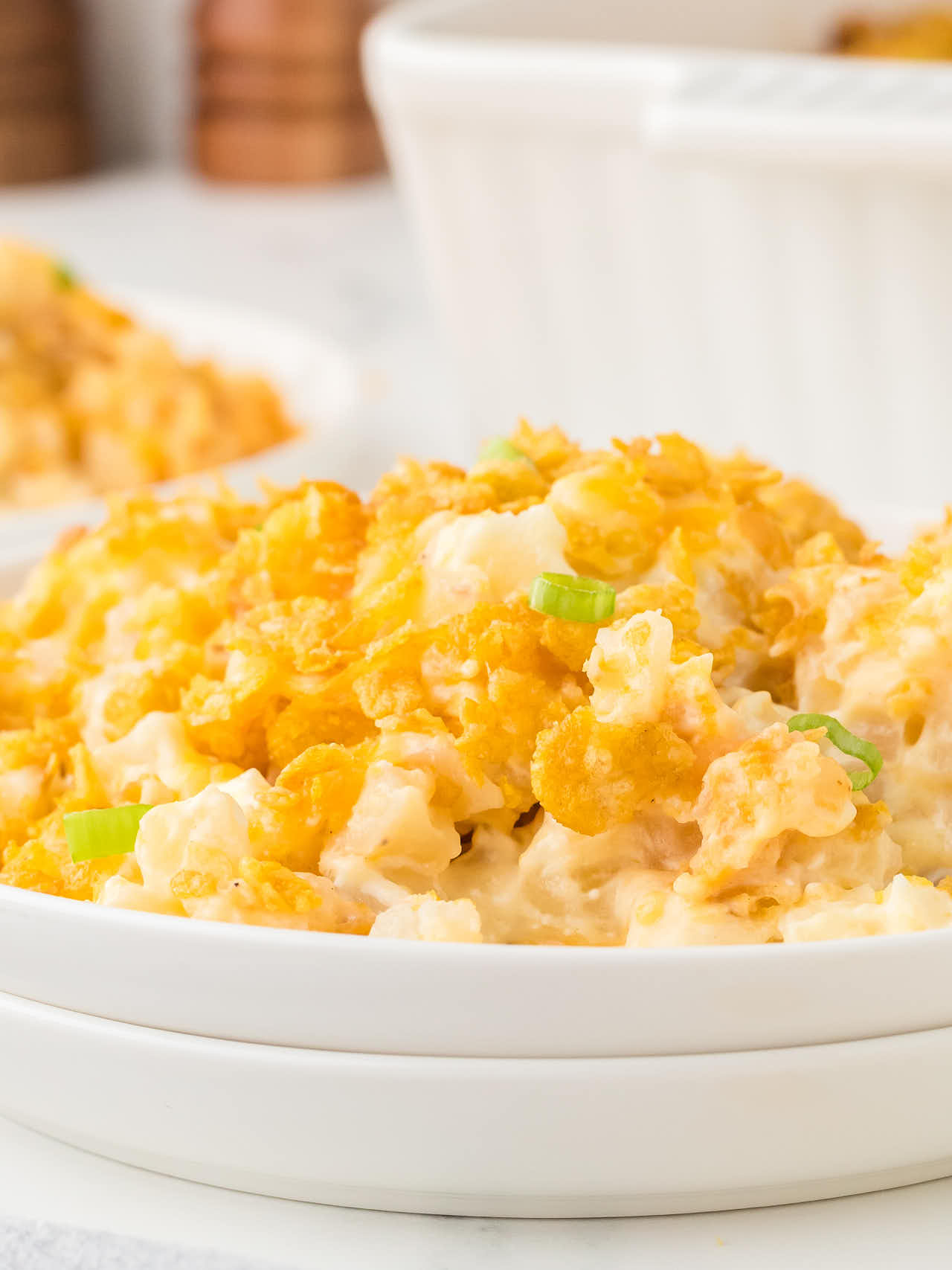 Funeral Potatoes served on a white plate.
