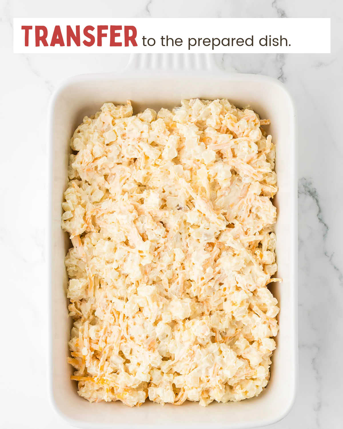 Cream cheese, hashbrowns, and cheese mixture in a baking dish.