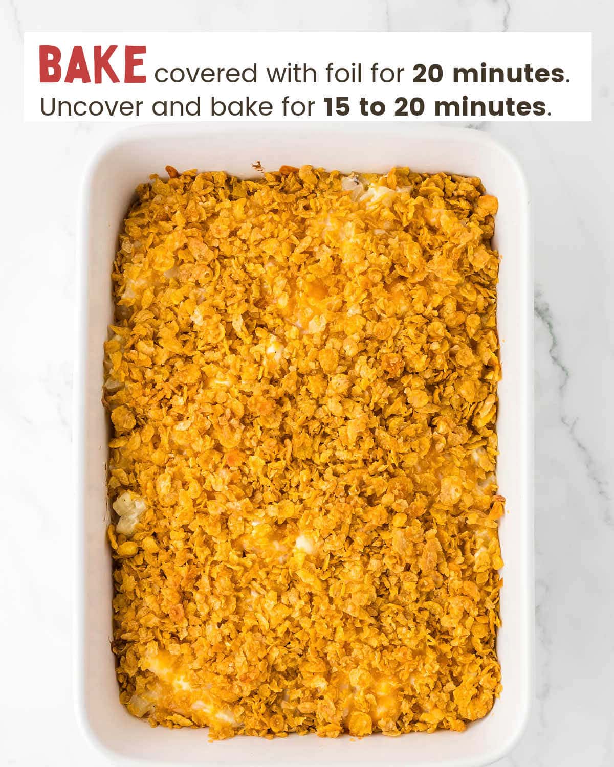 Funeral potatoes topped with cornflakes in a baking dish.