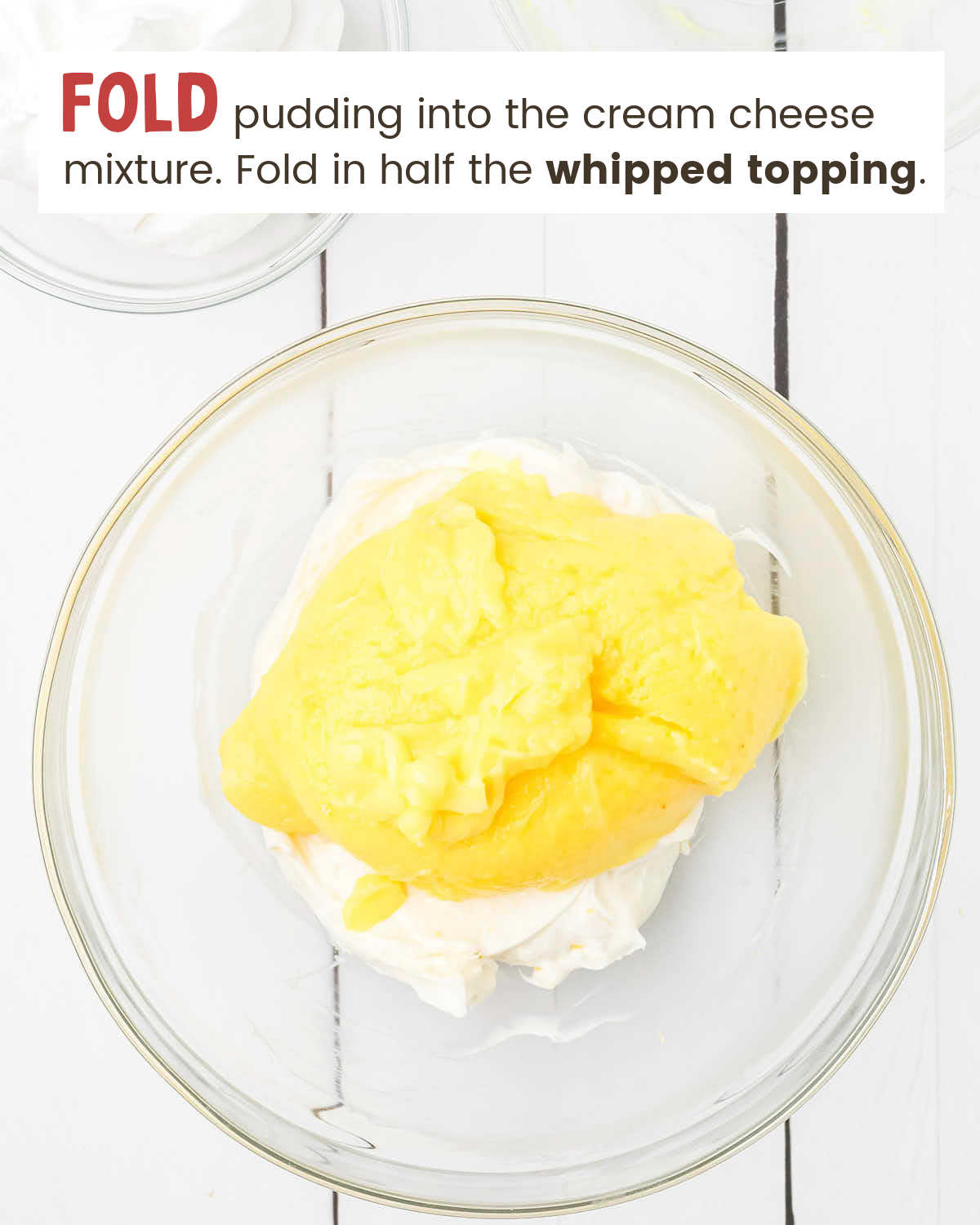 Lemon pudding on top of a cream cheese mixture in a bowl.