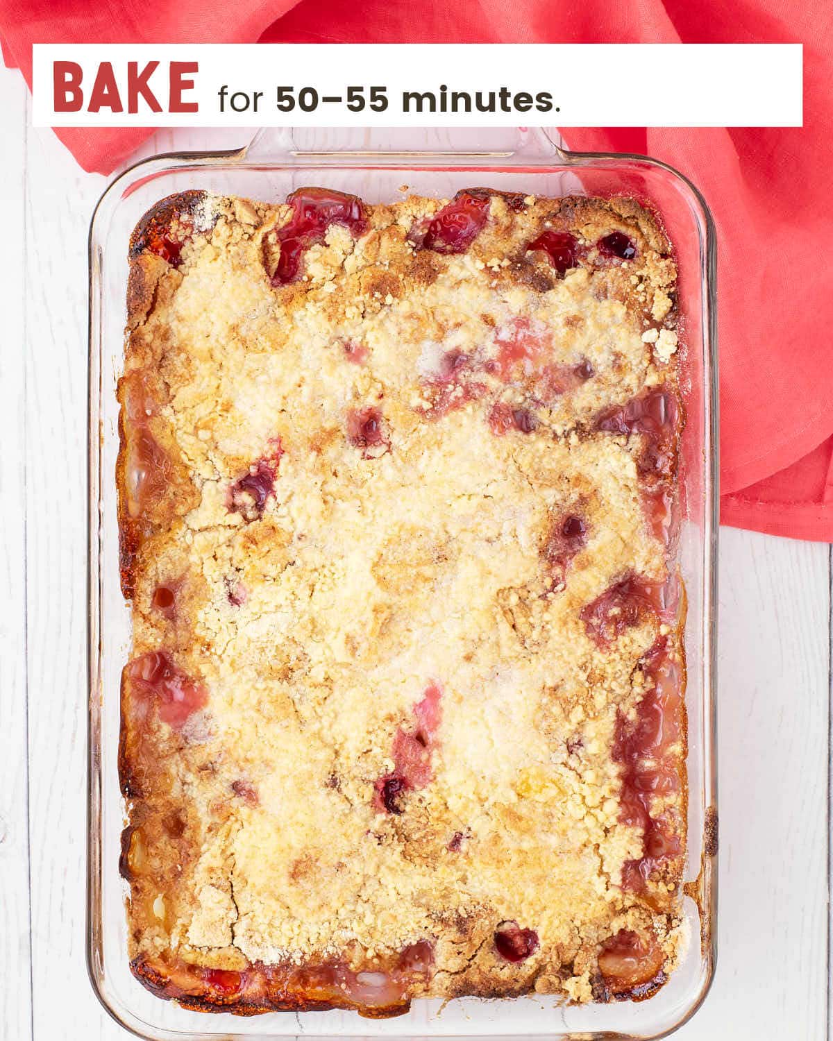 Peach melba dump cake in a 9x13" glass dish.