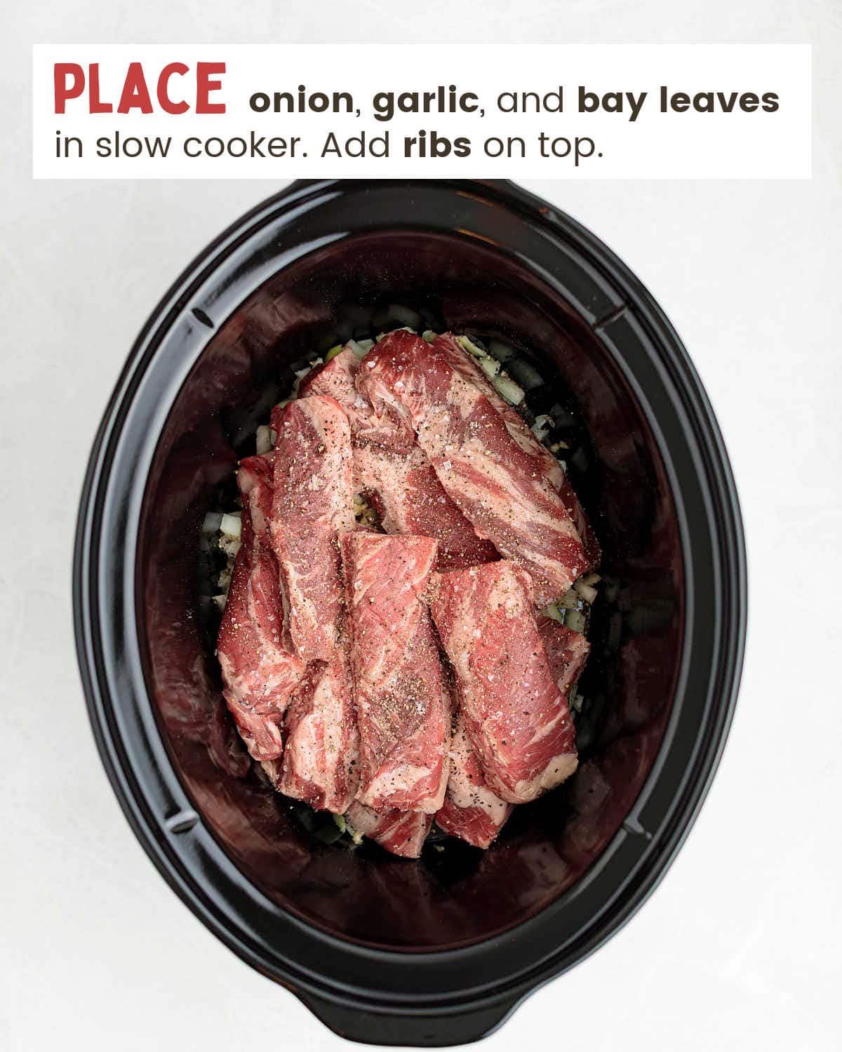 Raw beef ribs in a slow cooker.