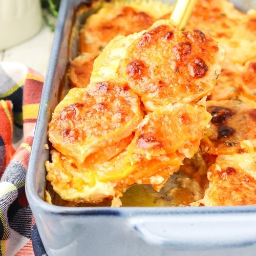 Lifting a Sweet Potato Gratin out of a casserole dish.
